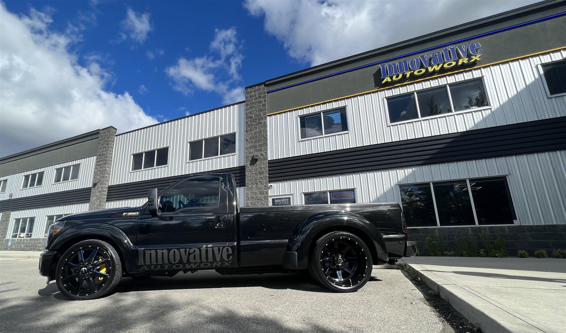 Truck parked in front of the Innovative Autoworx storefront.