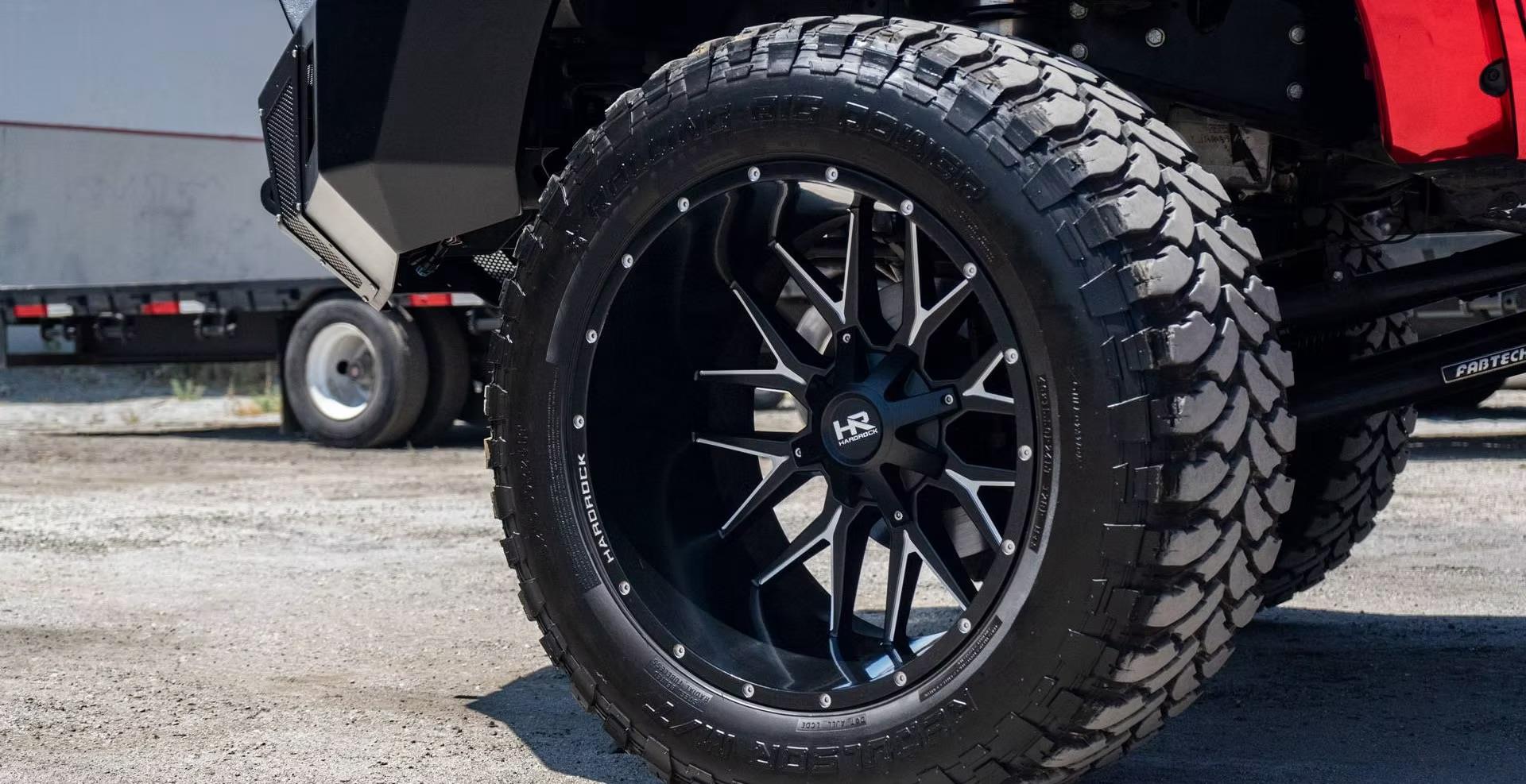 Red vehicle with HardRock wheels and Mickey Thompson tires
