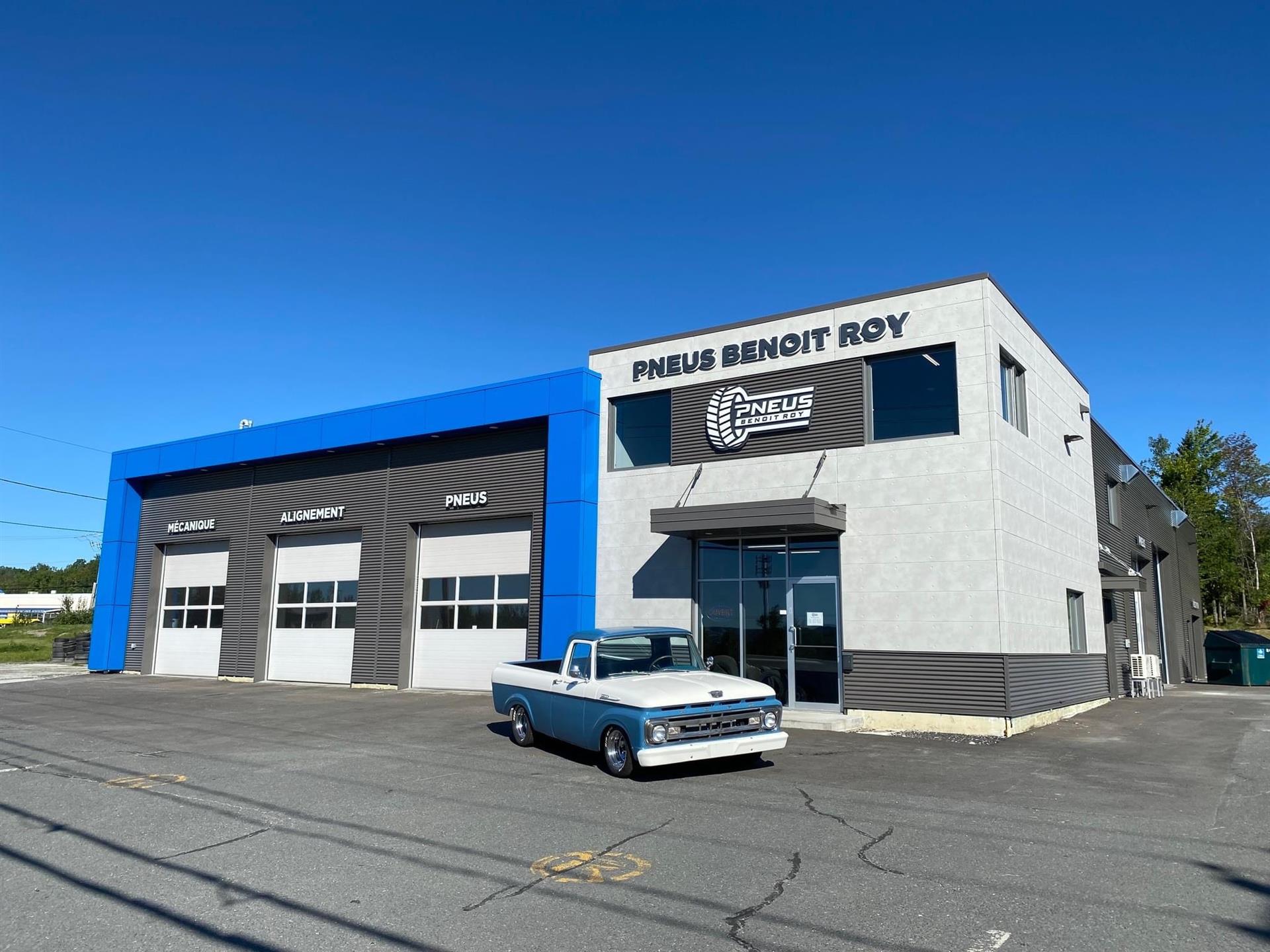 Pneus Benoit Roy white chevrolet in front of warehouse with winter tires