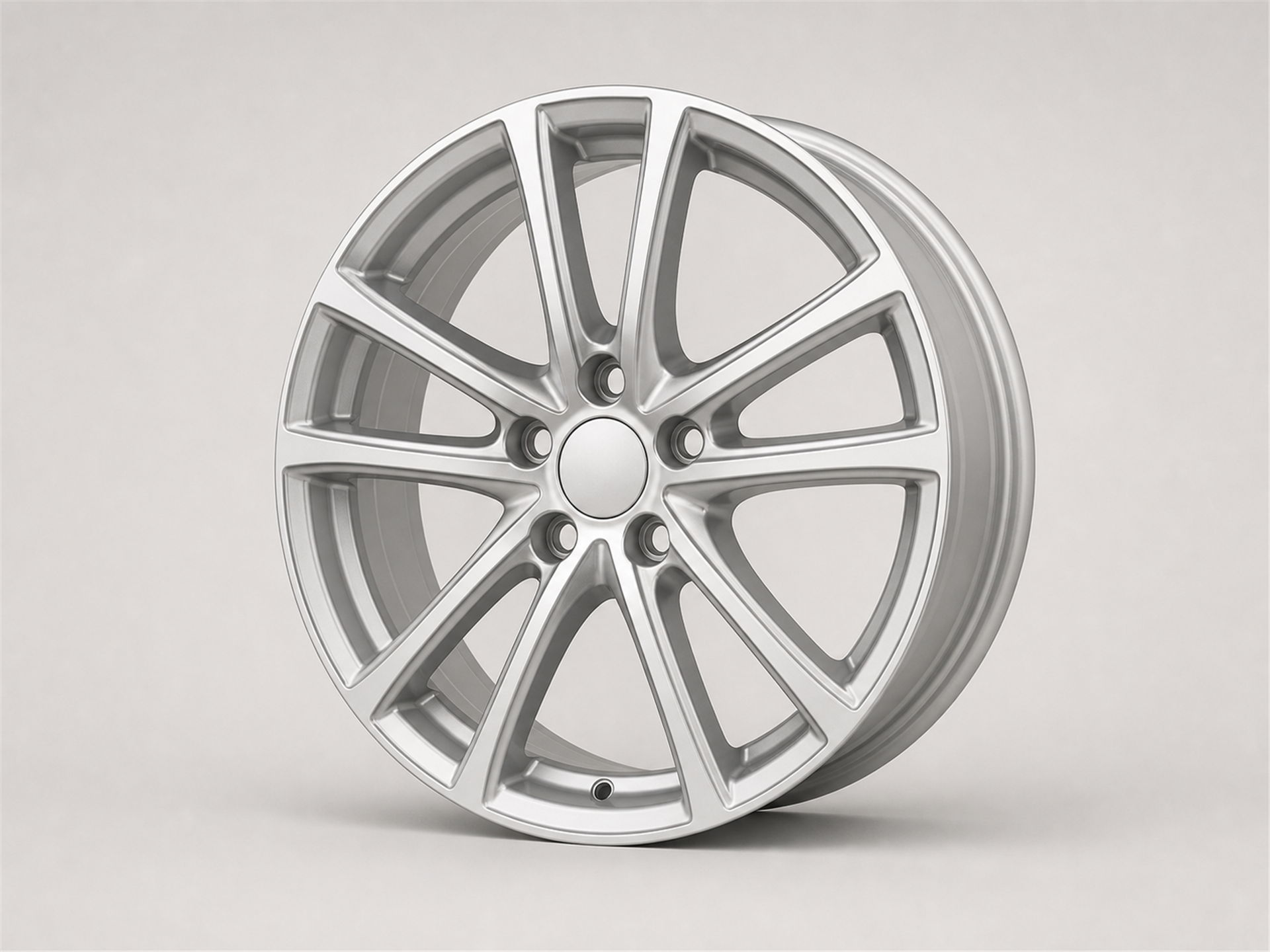 Unbranded satin silver alloy automotive wheel shown as a standalone studio product image on a light gray background.