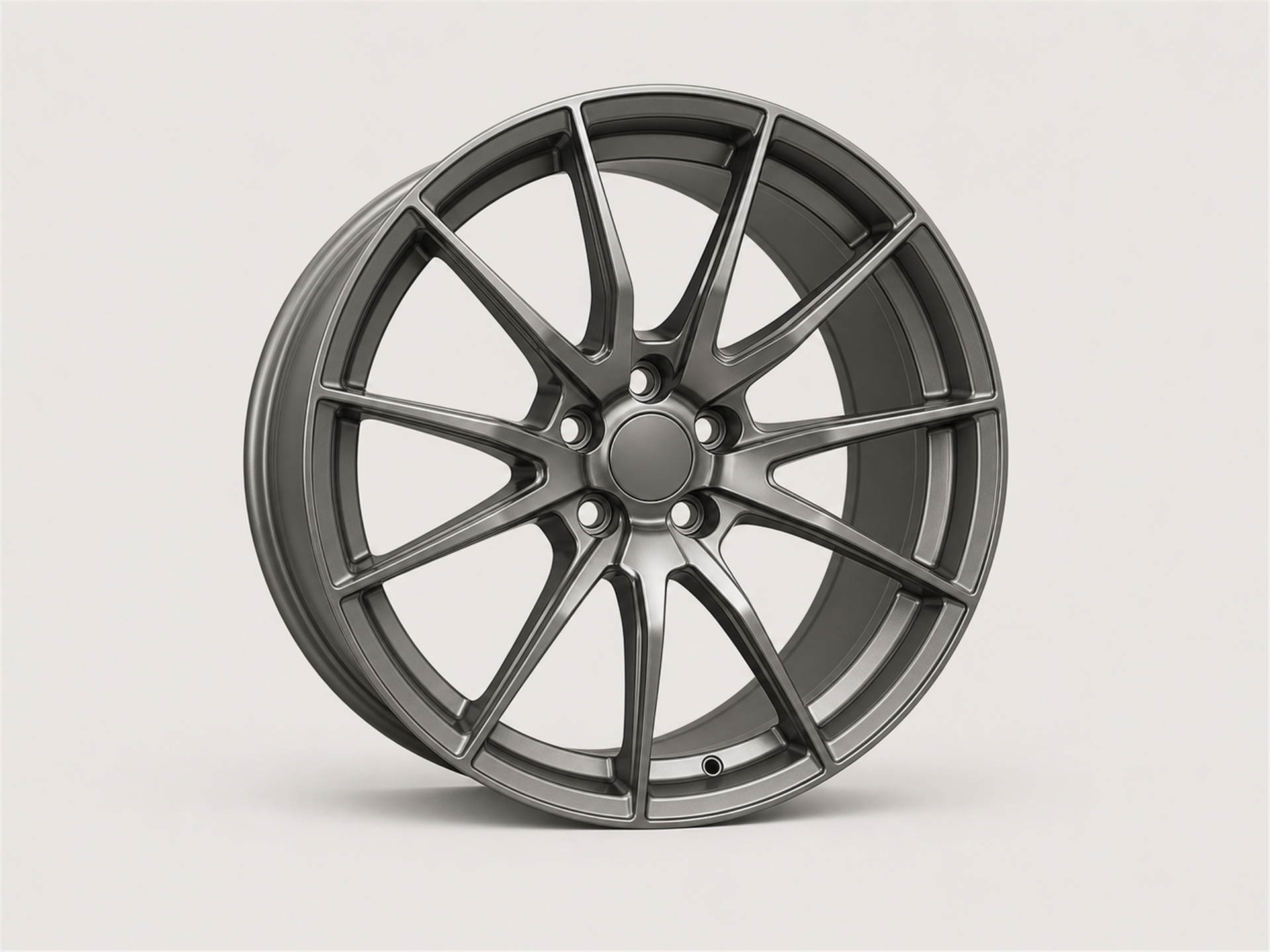 Unbranded satin gunmetal forged aluminum automotive wheel with thin split spokes shown as a standalone studio product image on a light gray background.