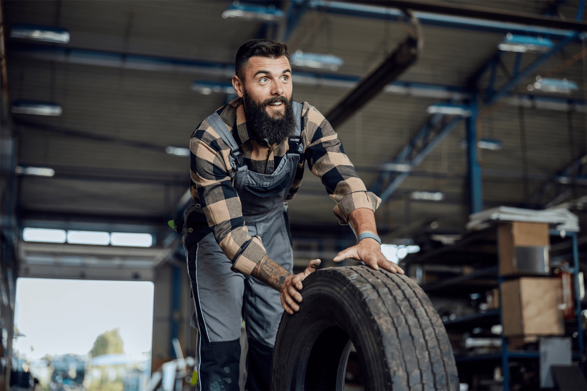 TreadXperts employee rolling a tire into our warehouse